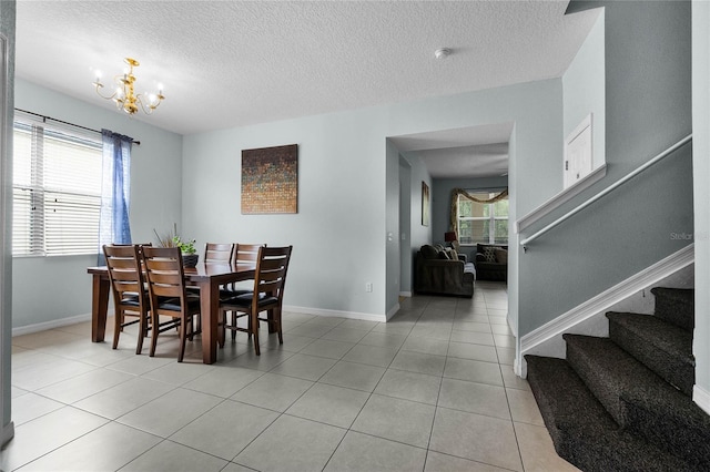 dining area with a wealth of natural light, a chandelier, stairway, and light tile patterned floors