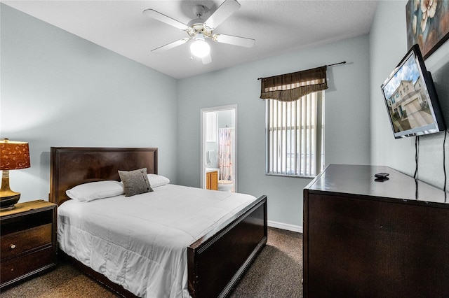 bedroom featuring connected bathroom, dark carpet, ceiling fan, and baseboards