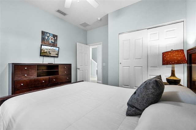 bedroom with a closet, ceiling fan, and visible vents