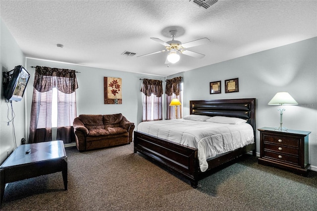 carpeted bedroom featuring visible vents, a ceiling fan, and a textured ceiling