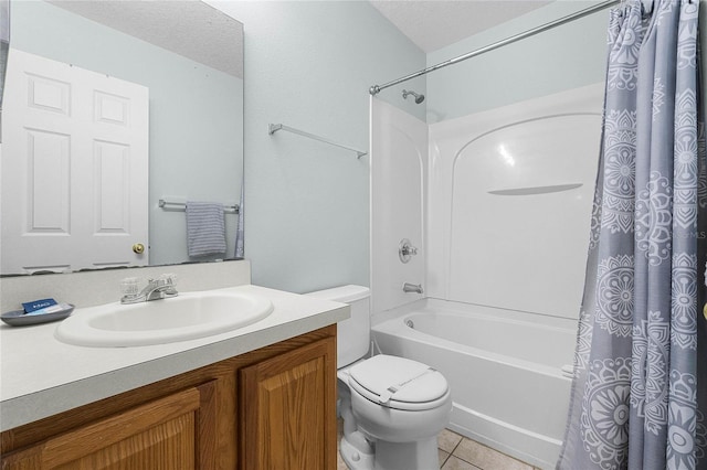 bathroom featuring toilet, vanity, a textured ceiling, tile patterned flooring, and shower / bath combination with curtain