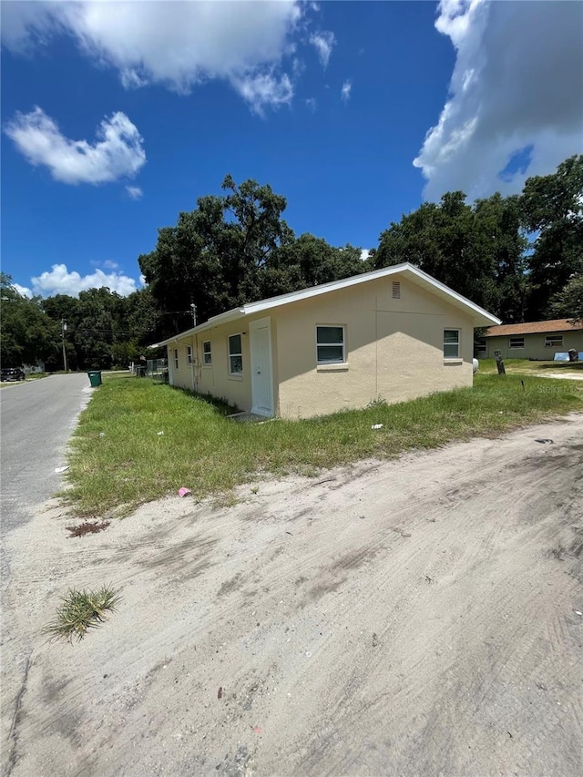 403 Terry St, Wildwood, FL 34785 - view of side of property with stucco siding
