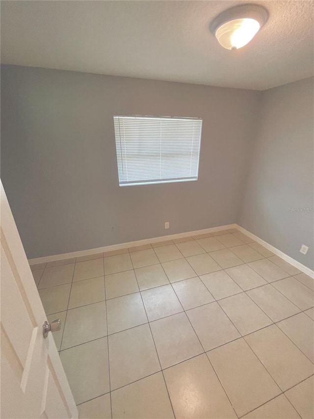 403 Terry St, Wildwood, FL 34785 - unfurnished room featuring baseboards and a textured ceiling