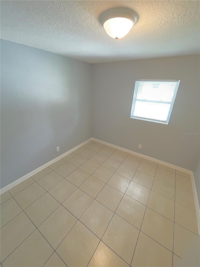 403 Terry St, Wildwood, FL 34785 - spare room featuring baseboards and a textured ceiling