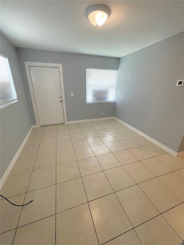 403 Terry St, Wildwood, FL 34785 - empty room featuring baseboards and light tile patterned floors