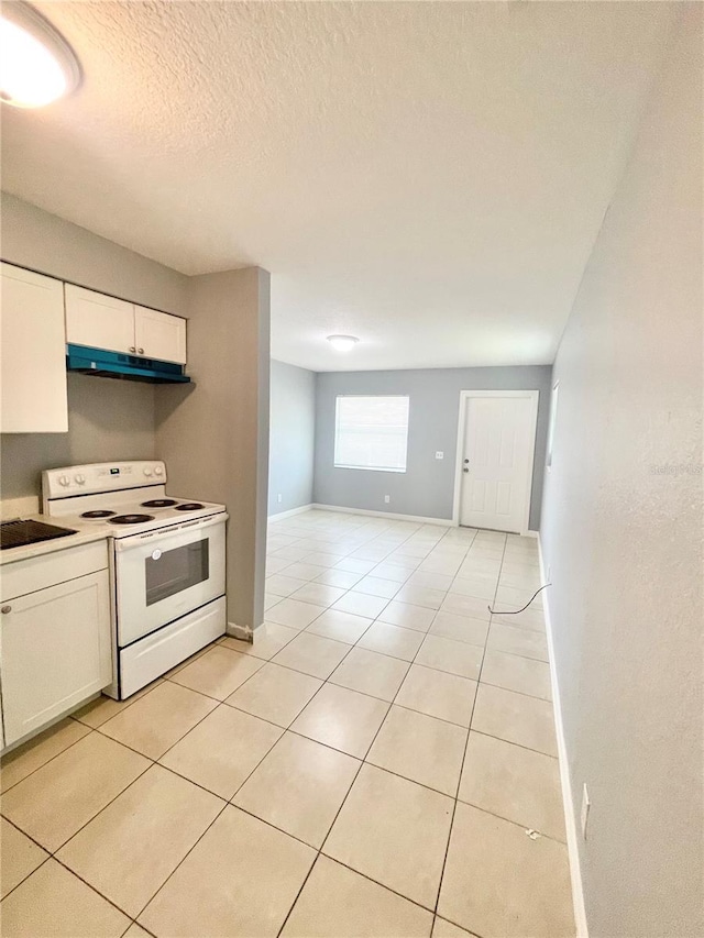 403 Terry St, Wildwood, FL 34785 - kitchen with under cabinet range hood, white cabinets, light tile patterned floors, and electric range
