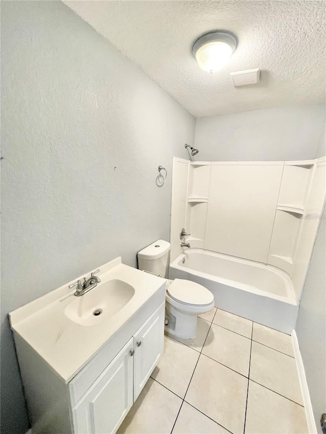 403 Terry St, Wildwood, FL 34785 - full bath featuring a textured ceiling, toilet, tile patterned floors, vanity, and bathing tub / shower combination