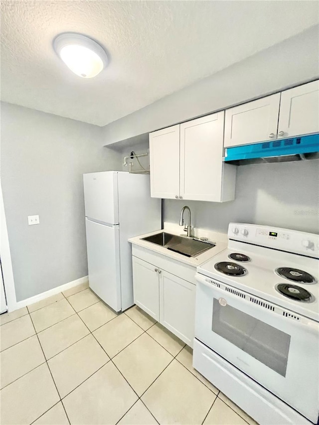 403 Terry St, Wildwood, FL 34785 - kitchen featuring white cabinets, a sink, under cabinet range hood, and white appliances
