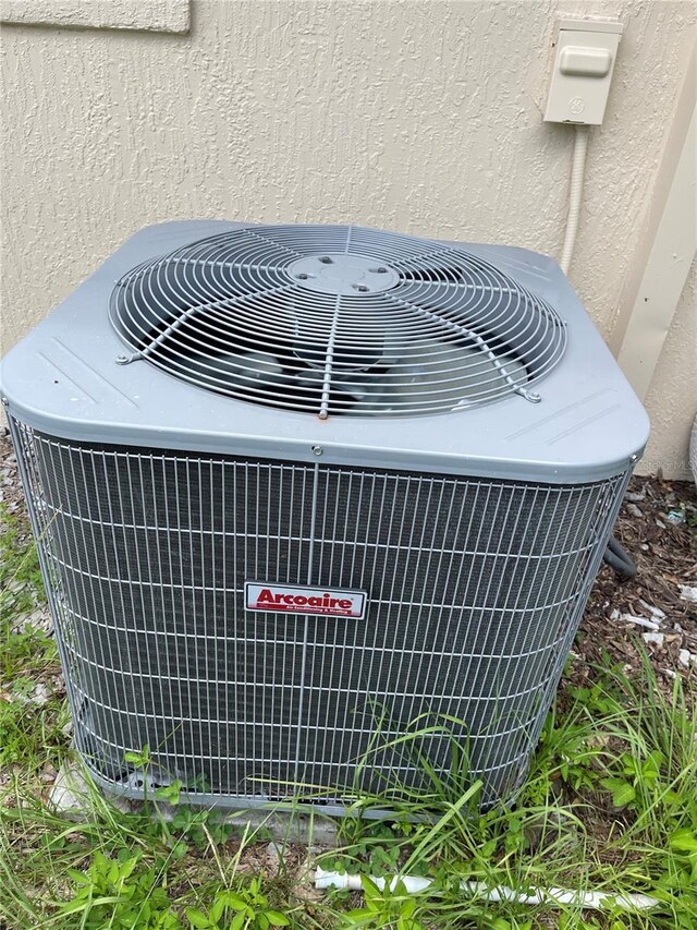 403 Terry St, Wildwood, FL 34785 - details with stucco siding and central air condition unit