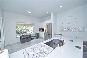 1237 Tallow Rd Unit 1237, Apopka, FL 32703 - kitchen featuring baseboards, marble finish floor, recessed lighting, and freestanding refrigerator