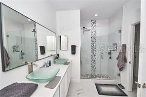 1237 Tallow Rd Unit 1237, Apopka, FL 32703 - bathroom with a stall shower, double vanity, and a sink