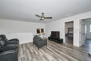 1237 Tallow Rd Unit 1237, Apopka, FL 32703 - living area featuring a ceiling fan and wood finished floors