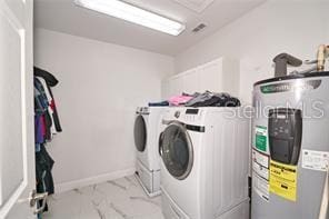 1237 Tallow Rd Unit 1237, Apopka, FL 32703 - washroom featuring washer and clothes dryer, laundry area, marble finish floor, baseboards, and electric water heater