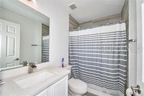 1237 Tallow Rd Unit 1237, Apopka, FL 32703 - bathroom with visible vents, curtained shower, toilet, and vanity