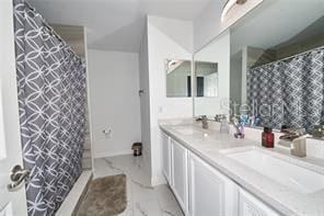 1237 Tallow Rd Unit 1237, Apopka, FL 32703 - bathroom featuring double vanity, curtained shower, and a sink