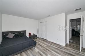 1237 Tallow Rd Unit 1237, Apopka, FL 32703 - bedroom with baseboards, visible vents, wood finished floors, and a closet