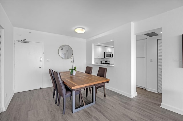 5600 Collins Ave Unit 6P, Miami Beach, FL 33140 - dining area with wood finished floors, baseboards, and recessed lighting