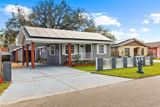 view of front of home with an attached carport, covered porch, fence, and a front lawn