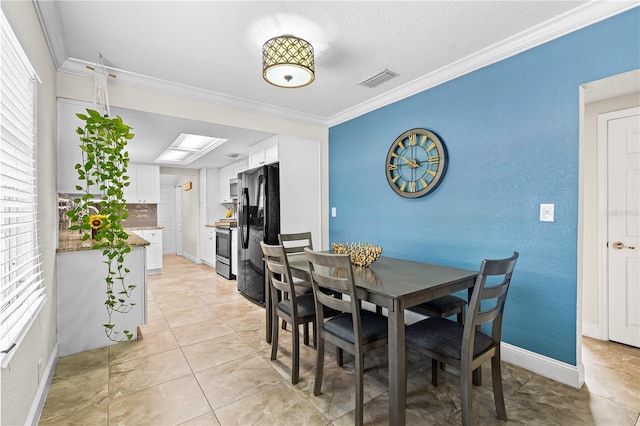 dining space with ornamental molding, a healthy amount of sunlight, and visible vents