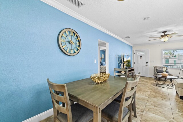 dining area with a ceiling fan, visible vents, crown molding, and a textured ceiling