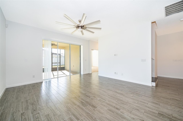 interior space featuring baseboards, visible vents, and wood finished floors