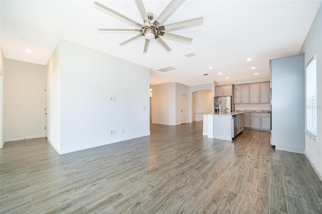 unfurnished living room featuring recessed lighting, baseboards, light wood finished floors, visible vents, and a ceiling fan