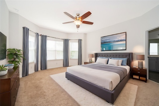 bedroom featuring a ceiling fan and light colored carpet