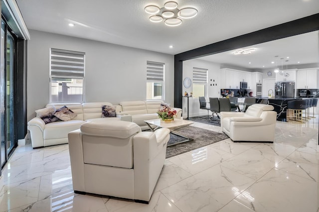2566 Trielle Ave, Kissimmee, FL 34741 - living room with marble finish floor, a textured ceiling, and recessed lighting