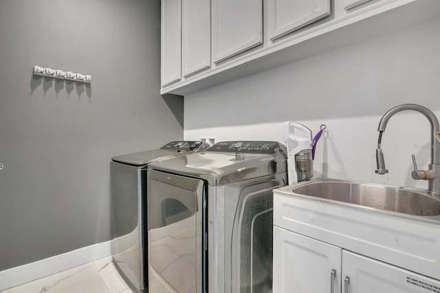 2566 Trielle Ave, Kissimmee, FL 34741 - laundry room with a sink, washing machine and clothes dryer, marble finish floor, baseboards, and cabinet space