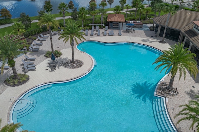 2566 Trielle Ave, Kissimmee, FL 34741 - community pool featuring a patio