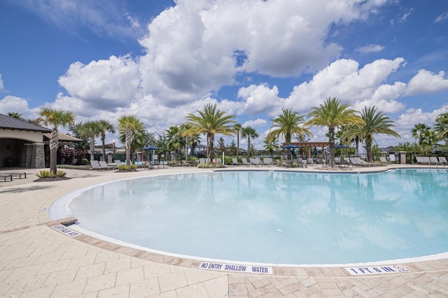2566 Trielle Ave, Kissimmee, FL 34741 - community pool featuring a patio area