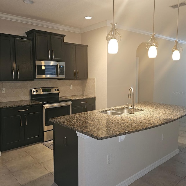 kitchen with a sink, tasteful backsplash, appliances with stainless steel finishes, visible vents, and dark stone counters