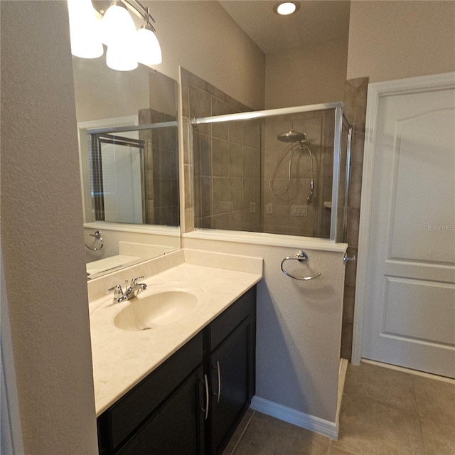 full bath with a stall shower, tile patterned flooring, and vanity