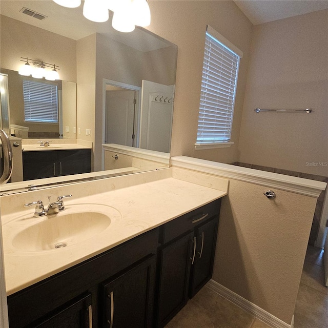 bathroom featuring visible vents, tile patterned flooring, and vanity