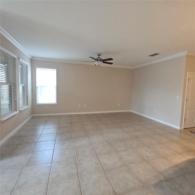 spare room with a ceiling fan, light tile patterned floors, baseboards, visible vents, and ornamental molding