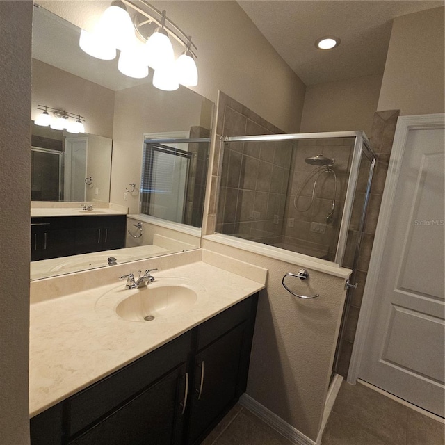 bathroom with vanity, tile patterned floors, and a shower stall