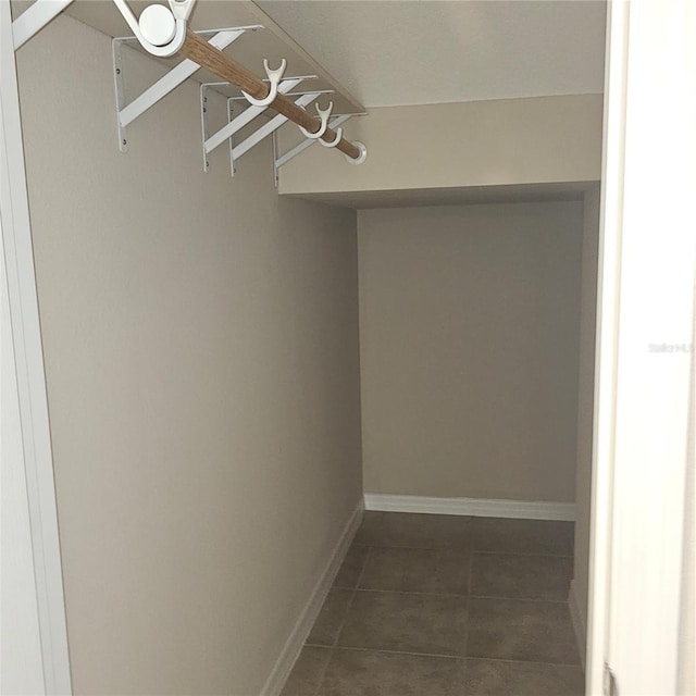 spacious closet featuring dark tile patterned floors