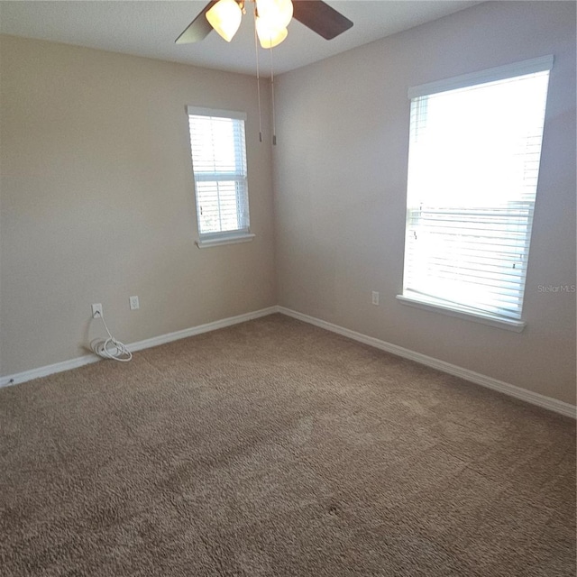 unfurnished room featuring baseboards, carpet floors, and ceiling fan