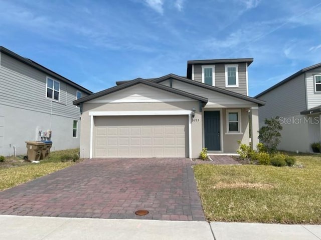 5273 Sanders Oak Trl, Saint Cloud, FL 34771 - view of front facade with a front lawn, an attached garage, decorative driveway, and stucco siding