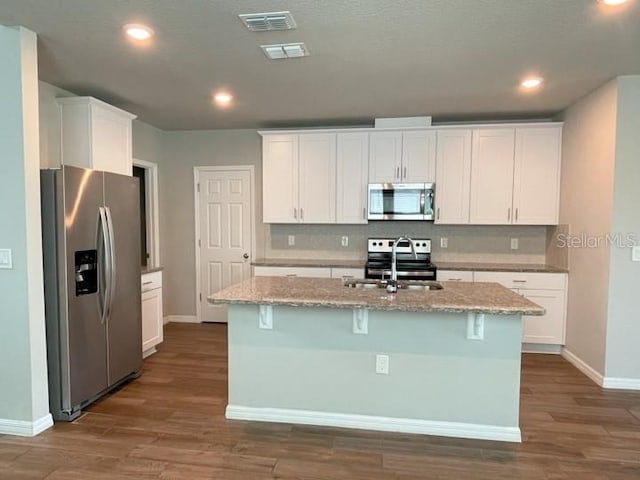 5273 Sanders Oak Trl, Saint Cloud, FL 34771 - kitchen with visible vents, a sink, appliances with stainless steel finishes, dark wood-style floors, and backsplash