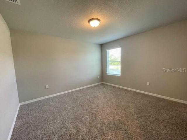 5273 Sanders Oak Trl, Saint Cloud, FL 34771 - carpeted spare room with visible vents, baseboards, and a textured ceiling