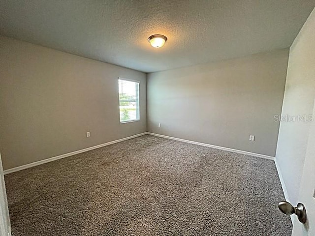 5273 Sanders Oak Trl, Saint Cloud, FL 34771 - spare room with carpet flooring, a textured ceiling, and baseboards