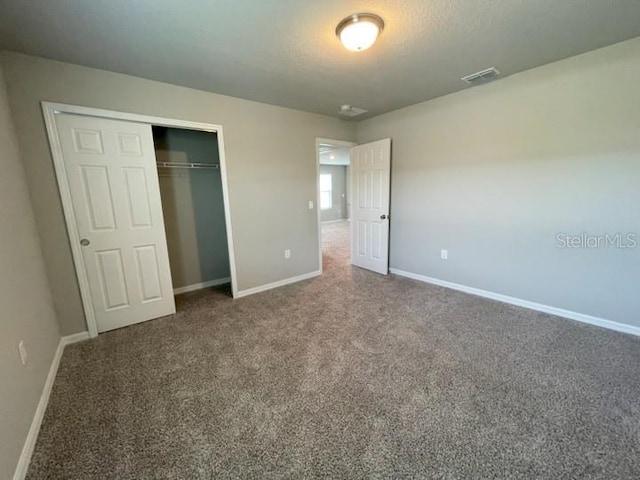 5273 Sanders Oak Trl, Saint Cloud, FL 34771 - unfurnished bedroom featuring a closet, carpet flooring, visible vents, and baseboards