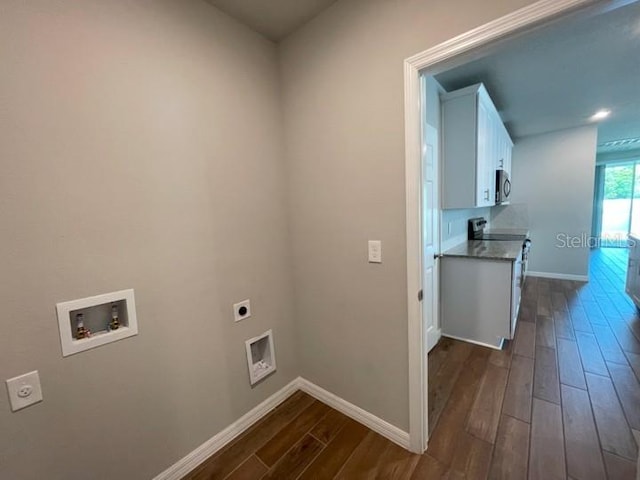 5273 Sanders Oak Trl, Saint Cloud, FL 34771 - clothes washing area featuring dark wood-style flooring, electric dryer hookup, baseboards, hookup for a washing machine, and cabinet space