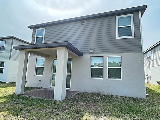 5273 Sanders Oak Trl, Saint Cloud, FL 34771 - back of property featuring a yard, stucco siding, and a patio area