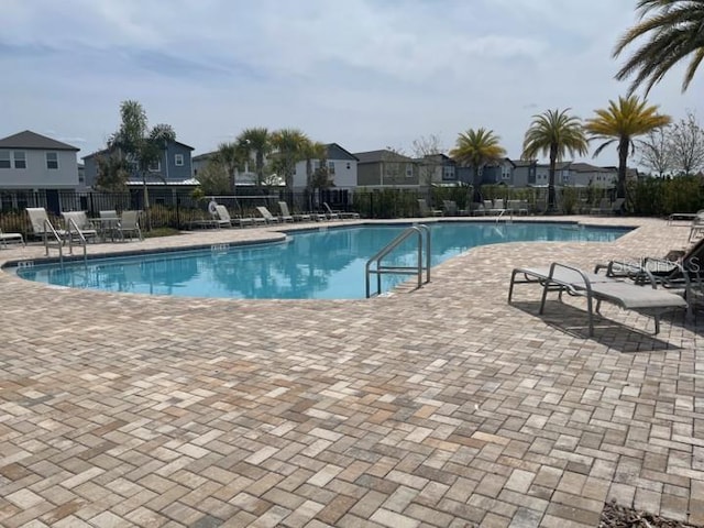 5273 Sanders Oak Trl, Saint Cloud, FL 34771 - community pool featuring a patio and fence