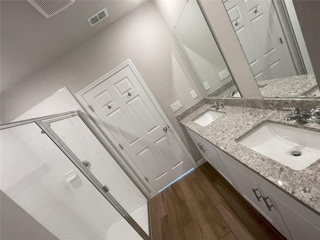 5273 Sanders Oak Trl, Saint Cloud, FL 34771 - bathroom featuring a shower stall, wood finished floors, a sink, and visible vents