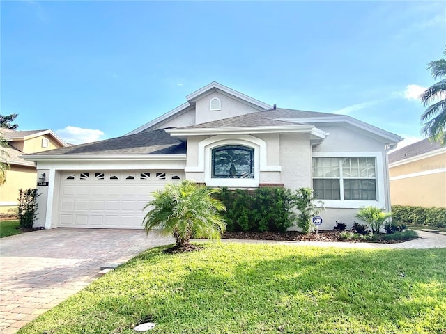 14313 Dulcimer Ct, Orlando, FL 32837 - single story home featuring a front yard, decorative driveway, stucco siding, a shingled roof, and an attached garage
