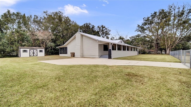 616 SE 31st Ter, Ocala, FL 34471 - back of house with a storage shed, an outdoor structure, a sunroom, and view of wooded area