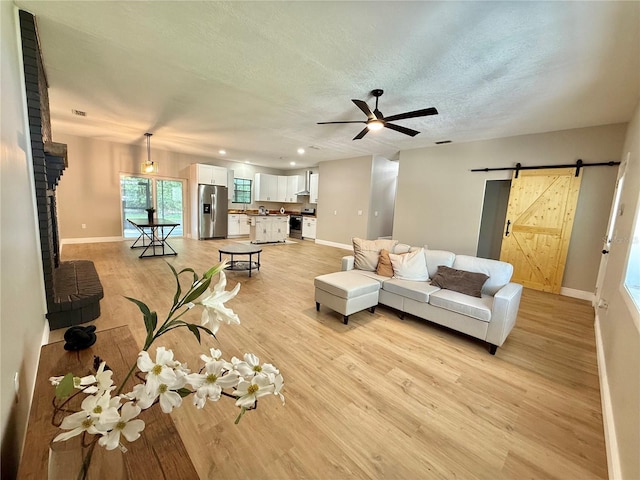 616 SE 31st Ter, Ocala, FL 34471 - living area featuring a barn door, light wood-style flooring, baseboards, ceiling fan, and recessed lighting